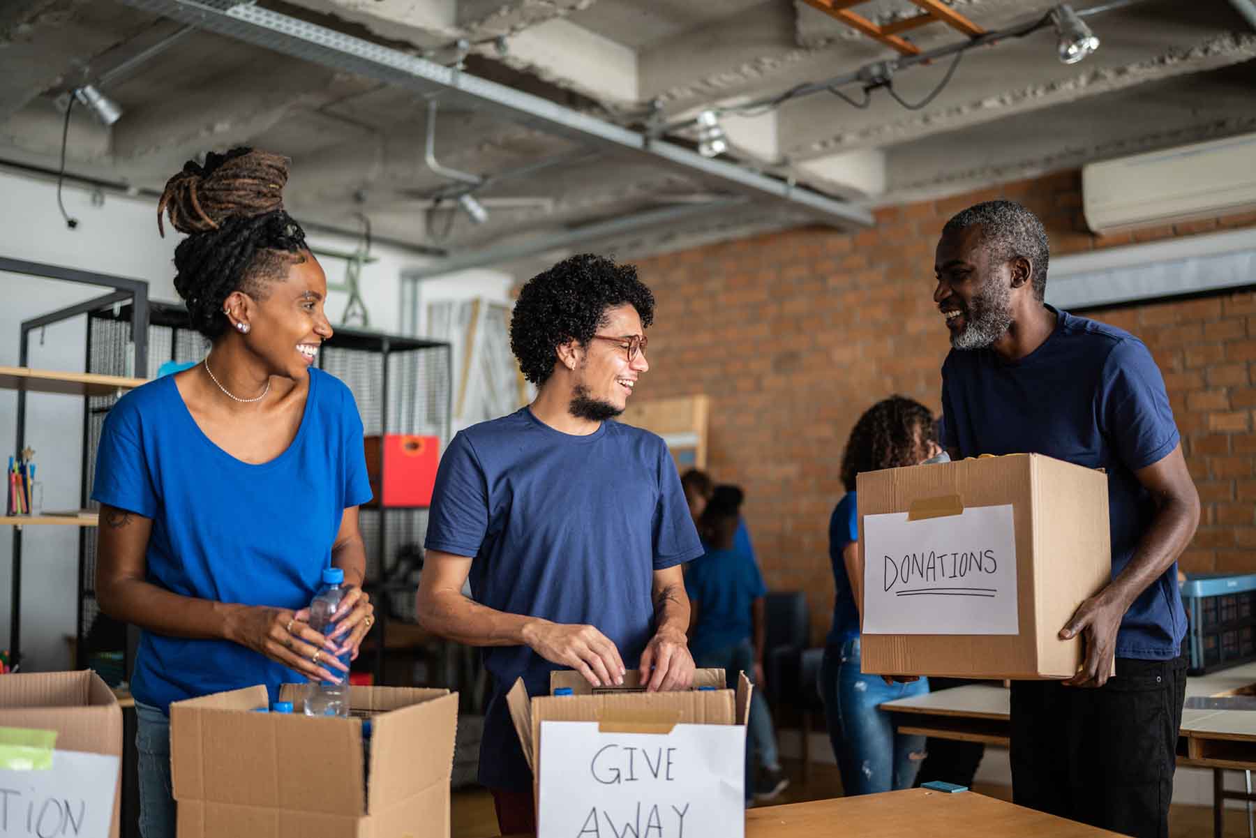 Volunteers arranging donations in a community charity donation center