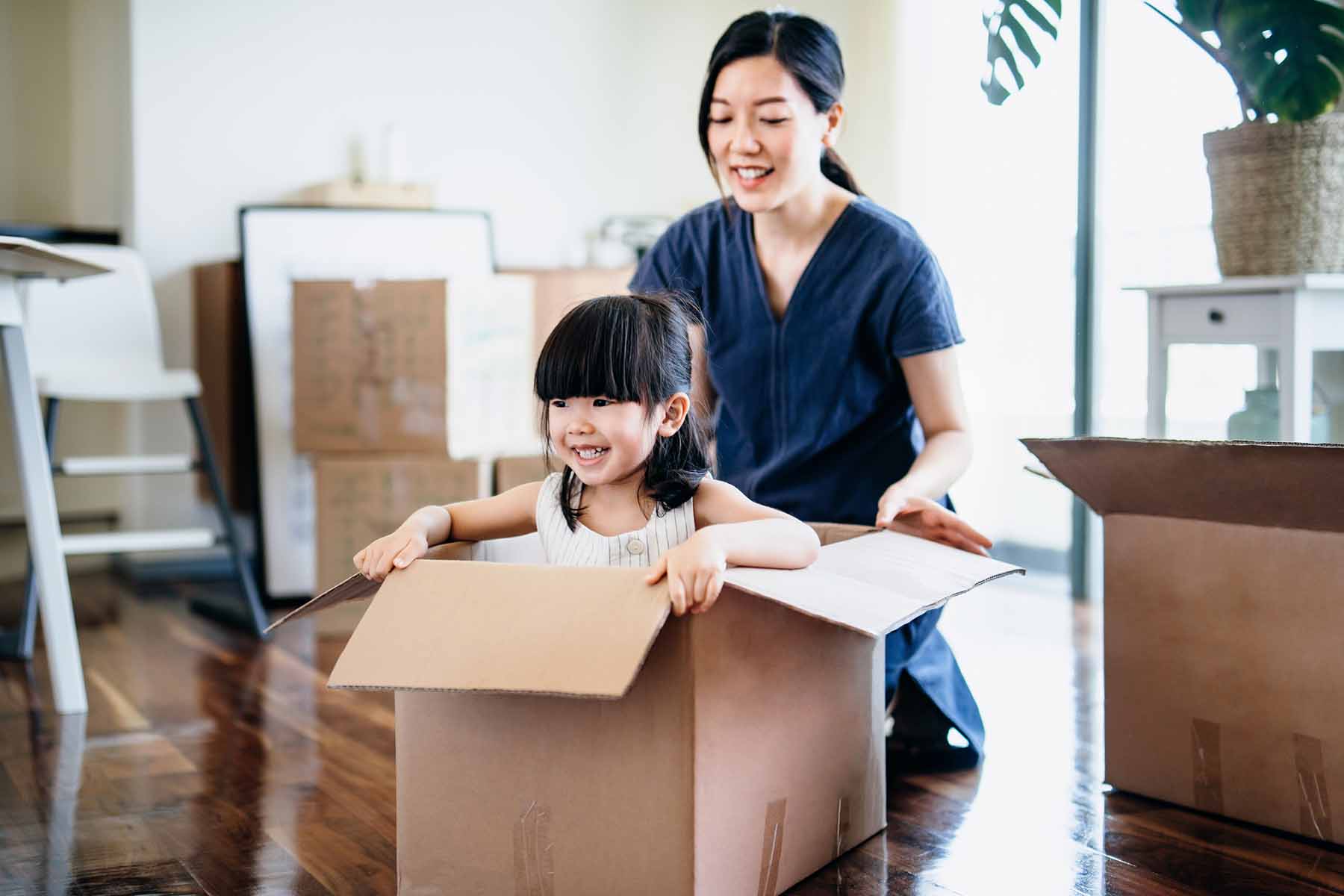 Young mother and daughter moving to a new apartment.