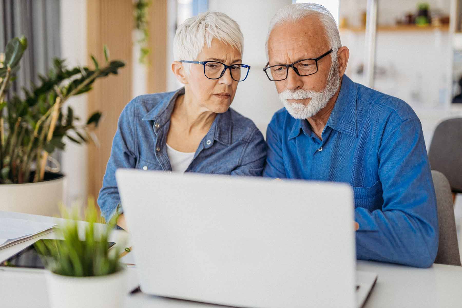 Senior couple reviewing online security