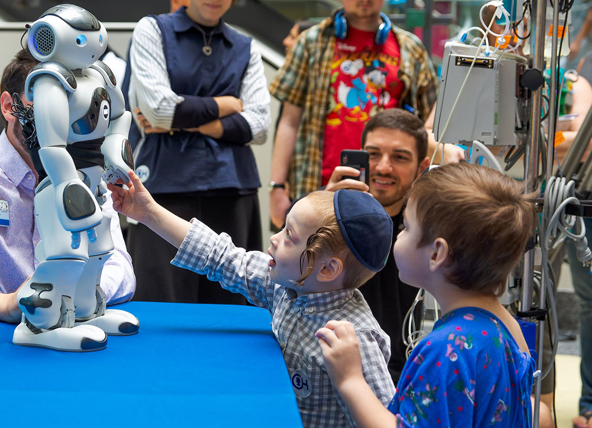 Kids looking at robot on table at Childrens Hospital of Philadelphia