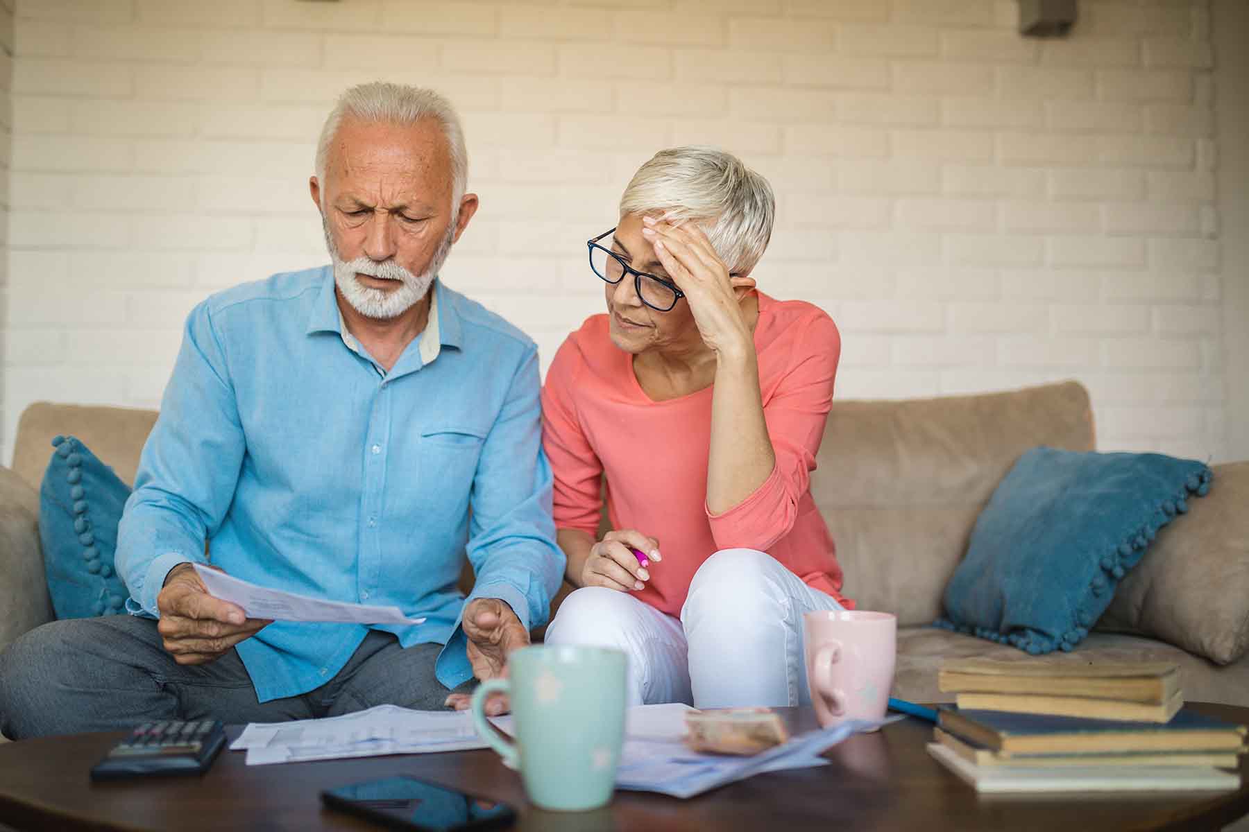 Senior couple sitting and solving a financial issue together