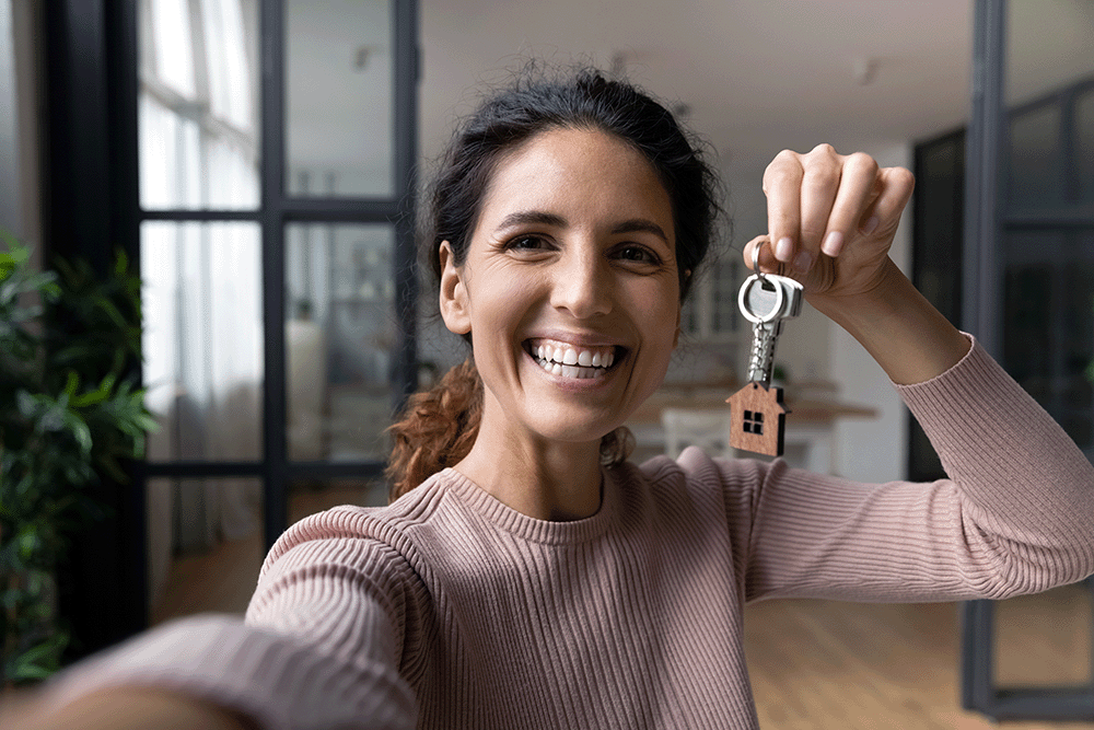A woman holding the keys to her new home