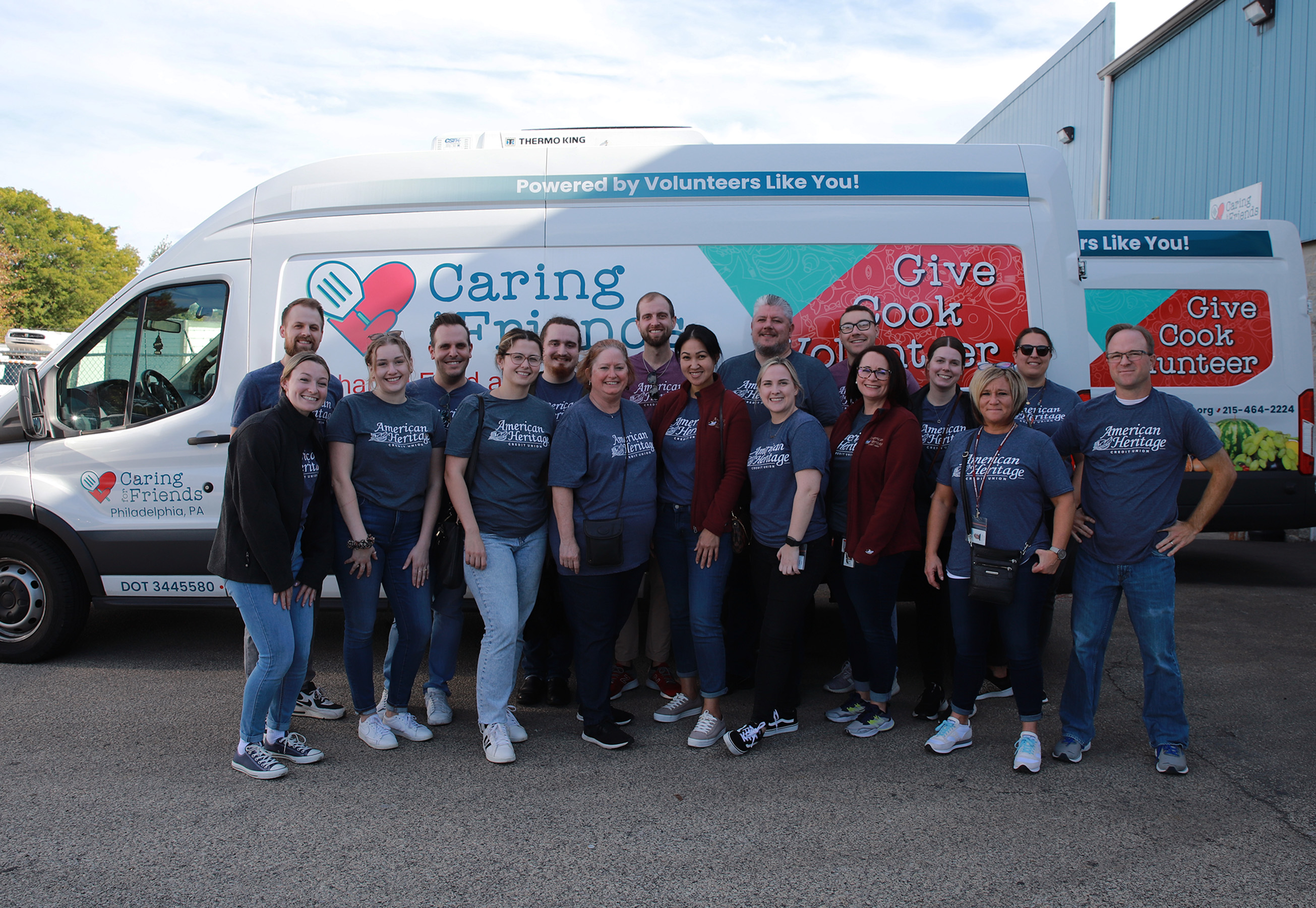 American Heritage Associates stand in front of Caring for Friends vehicle.