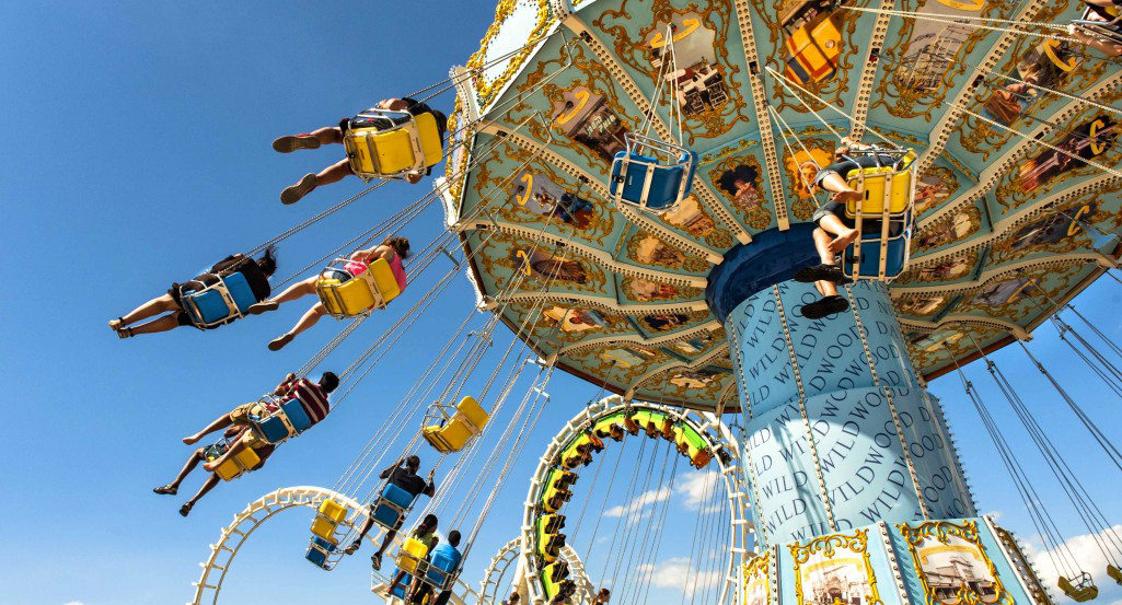 People riding Morey's Piers Wave Swinger