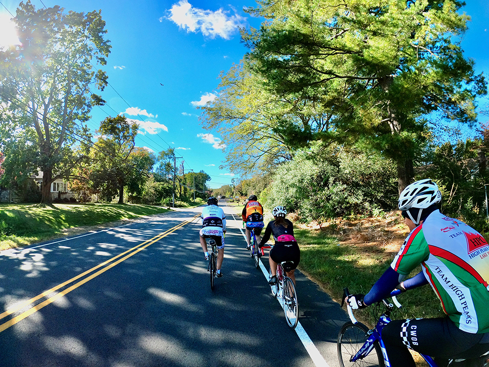 Four riders take part in a bike-a-thon on a street